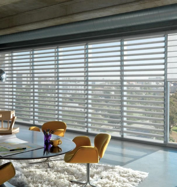 Sheer banded blinds across the windows of an open-plan office