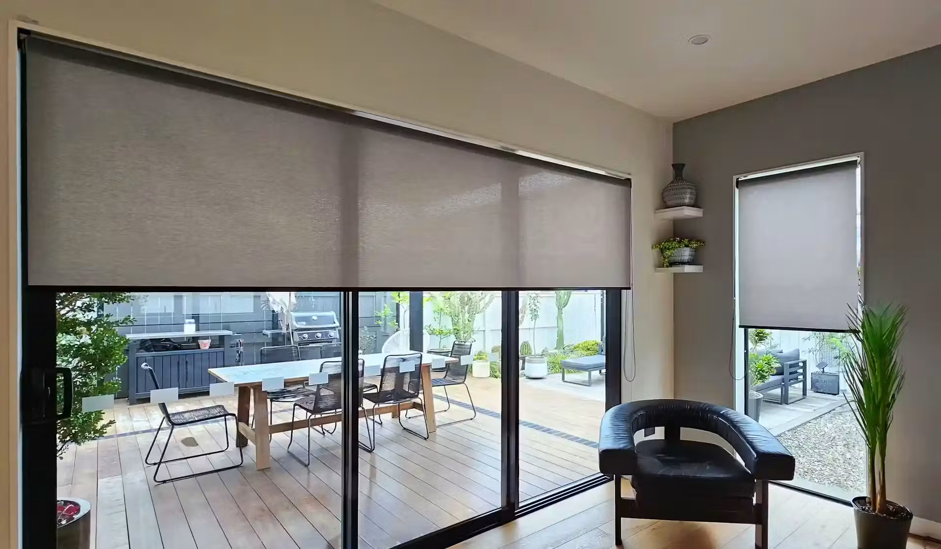 Roller blinds on sliding doors opening onto a timber deck